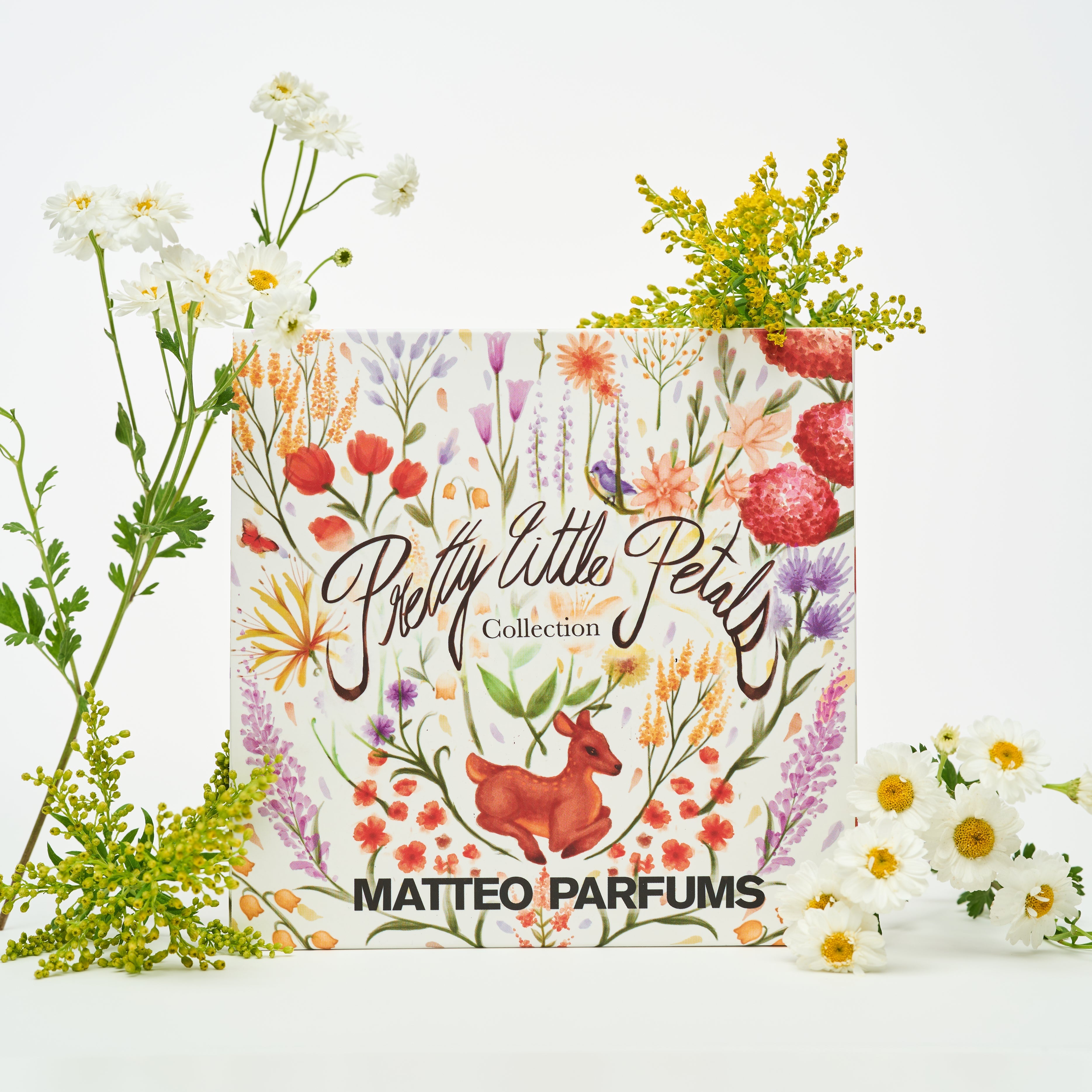 Floral decorative box packaging labeled 'Pretty Little Petals Collection' by MATTEO PARFUMS with white flowers on a white background.